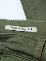 Close-up of Blue de Gênes Paulo Pavia 1 V2 Chino - Army in green stretch cotton. Features Made in Italy label beside a small Italian flag, with distinctive orange stitching on the fabric.