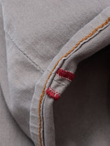 Close-up of gray Paulo Pavia 1 V2 Chino - Fungi by Blue de Gênes, featuring brown stitching and two short parallel red stitches along the seam.