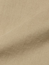 Close-up of the Paulo Pavia 1 V2 Chino in Khaki by Blue de GĂȘnes, showcasing beige fabric with a subtle diagonal weave and soft fold that highlights the smooth textureâideal for classic chino pants.