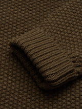 Close-up of Blue de GĂȘnes Aimone Knit Cardigan - Army in a textured brown lambswool. The folded ribbed hem and waffle pattern give the cardigan a cozy, warm appearance.