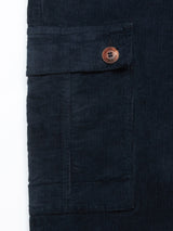 Close-up of the Albi Cargo Pant in Dark Navy by Blue de Gênes, showcasing its cross-cord comfort style with a side pocket and brown button, reminiscent of loose-fit cargo pants.