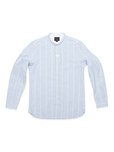 The Basso Hackney Shirt by Blue de Gênes is a light blue long-sleeve button-up cotton shirt with white vertical stripes, a band collar, and subtle logo embroidery on display against a pristine white background.