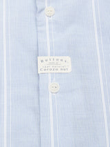 Close-up of the Blue de Gênes Basso Hackney Shirt with blue and white vertical stripes. White buttons are crafted from real Corozo nut, and subtle logo embroidery enhances its elegance.