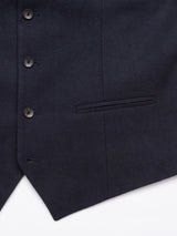 Close-up of the Canna Carbonio Gillet in Dark Navy by Blue de Gênes reveals textured fabric with Buffalo horn buttons and a pocket. Buttons are evenly spaced, and fabric looks like smooth, well-tailored Italian brushed cotton.
