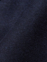 Close-up of the dark navy Canna Carbonio Gillet by Blue de Gênes, featuring textured fabric with visible weave patterns. Made from Italian brushed cotton, it appears soft and slightly glossy, with light and shadow emphasizing its folds.