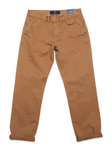 A pair of Franco Genes Chino - Biscotto by Blue de Gênes laid flat on a white background, showcasing their relaxed fit, button closure, side pockets, subtle creases, and cuffed hems. A blue tag is attached to the waistband.