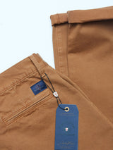 The expertly folded Franco Genes Chino in Biscotto by Blue de Gênes features a blue label and a French tag. Made from Saia twill, it comes with a button-closure pocket and a handy hanging loop.
