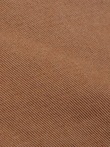 Close-up of Franco Genes Chino - Biscotto by Blue de Gênes, featuring brown twill fabric with a diagonal weave pattern.
