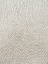 Close-up of the Gabbiano Winnot Blazer - Natural by Blue de Gênes, showcasing a light beige cotton-linen fabric with a subtle herringbone pattern and woven chevron motifs, ideal for creating a relaxed yet stylish look.
