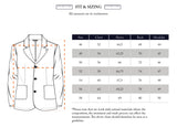 A depiction of the Gervaso Tarlo Blazer - Navy by Blue de Gênes alongside a size chart in centimeters. Sizes range from 46 to 58, detailing chest, sleeve, back, and shoulder measurements. Note that natural materials or corozo buttons might impact measurements.