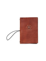 The BDG Leather Journal - Brown by Blue de Gênes is expertly crafted from premium bull leather. It features a black elastic band, an embossed tree logo, and offers a vintage, rustic aesthetic thats perfect for capturing your thoughts.