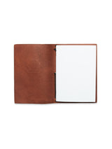 The BDG Leather Journal - Brown by Blue de Gênes features an A5 vintage look crafted from premium bull leather, with an open brown cover revealing a blank white page ready for your thoughts.