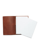 The Blue de Gênes BDG Leather Journal - Brown features a premium bull leather cover that holds two white A5 notebooks. The interior is simple and unadorned, with the notebooks offering a minimalist yet vintage aesthetic.