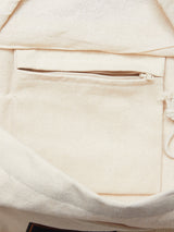 Close-up of an open Blue de Gênes BDG Canvas Bag in off-white, perfect for daily use; it includes a soft-textured fabric, visible stitching, and a spacious, unadorned interior with an interior pocket featuring a closed golden zipper.