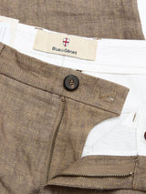 Close-up of BGpalco Lin Pants - Grey Mel by Blue de Gênes, featuring a relaxed fit, visible brand waistband label, brown button, and partially open brass zipper revealing a white inner lining—a true summer staple.