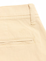 Close-up of the back pocket on Blue de Gênes BGmenzino Vecchio Shorts in Pale Khaki, featuring a stitched shield emblem above the pocket and a belt loop at the waist.