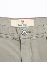Close-up of the waistband and button on BGmenzino Vecchio Shorts - Shadow Green by Blue de Gênes, highlighting a metal button and an inner label with the brand’s name and a shield emblem.