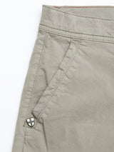 Close-up of the upper section of the BGmenzino Vecchio Shorts in Shadow Green by Blue de Gênes, highlighting a side pocket with visible stitching and a small shield-shaped logo patch near the pocket opening.