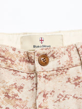 Close-up of the waistband of Blue de Gênes BGcupra Print Shorts - Multi Pattern, featuring a brown button and brand label above the fly.