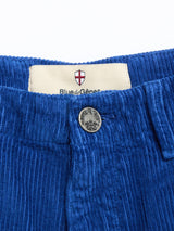 Close-up of BGfloyd Cord Shorts in Navy Peony by Blue de Gênes, showing a metal button and a label with the red and white shield logo.