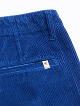 Close-up of BGfloyd Cord Shorts - Navy Peony by Blue de Gênes, showing the ribbed corduroy texture and a back pocket with a small beige tag featuring a red shield logo.