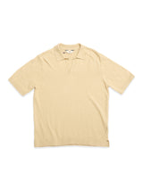 The BGjohn Slubby Polo in Pale Khaki by Blue de Gênes—a short-sleeve cotton knit polo with a collar and V-neck opening—offers an effortless nod to vintage leisurewear.