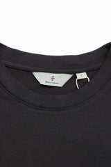 Close-up of the crewneck on a BGoscar T-Shirt - Jet Black from Blue de Gênes, showing the inner tag with brand and size L. Made of 100% cotton.