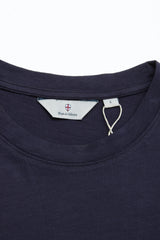 Close-up of the BGoscar T-Shirt in Dark Navy by Blue de Gênes, showing its crewneck, visible brand label, and size L tag on a plain white background. Crafted from 100% cotton.