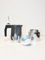 The BDG Coffee Maker - Grey by Blue de Gênes is shown disassembled into base, filter basket, and pot with black handle, arranged on a white surface against a plain background.