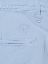 Close-up of Blue de Gênes BGmenzino Vecchio Shorts in Blue Fog, featuring lightweight cotton, a stitched pocket with a cross-embroidered shield emblem above it, and belt loops.