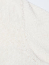 Close-up of the BGjohn Slubby Polo in Chalk by Blue de Gênes, highlighting its cream-colored knit fabric and fine seam details—capturing the soft, vintage-inspired texture and comfort of classic leisurewear.