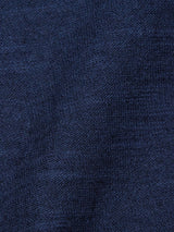 A close-up of the Monte Knit - Navy by Blue de Gênes reveals its textured weave, reminiscent of a classic crewneck jumper. The dark blue denim fabric has a slightly wrinkled appearance, with subtle shading variations that create a soft, natural look.