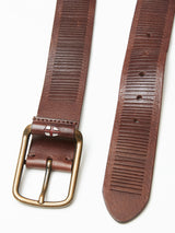 The Obla Belt in Dark Brown by Blue de Gênes is a handmade belt featuring a full grain leather finish and an antique brass buckle. It includes horizontal grooves and adjustable holes, shown on a white background.