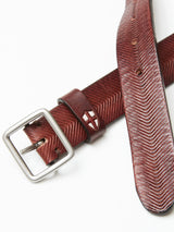 The Pento Belt - Brown by Blue de Gênes, handcrafted in Italy from full grain bull leather with a herringbone pattern and square silver buckle, is displayed on a white background. Partly unbuckled, it shows a small cut-out design near the buckle.