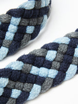 Close-up of the Pratese Belt by Blue de Gênes, featuring two intertwined braids in shades of blue and gray. The soft, plush texture resembles cotton webbing, with a checkerboard pattern showcasing intricate, hand-made craftsmanship.