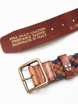 Close-up of the Blue de Gênes Pratese Belt - Brown, featuring a brass buckle, braided blue and brown cotton webbing, and vegetable-tanned full-grain leather handmade in Italy, with a small shield emblem near the buckle.