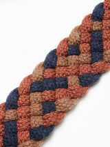 Close-up of the Pratese Belt - Brown by Blue de Gênes, showcasing its intricate braid pattern made from braided cotton webbing. The interconnected threads in blue, brown, and rust hues form a textured and colorful design against a white background.