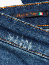 Close-up of Repi Dragon Dark Used Jeans - Denim Blue by Blue de Gênes, featuring regular slim fit, orange stitching, and distressed patch. A black Repi Jeans label with Made in Italy and an Italian flag adorns the comfort stretch denim fabric.