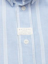 The Sandro Caicos Shirt by Blue de Gênes features a light blue Oxford design with white pinstripes, crafted from 6oz fine stripe fabric. It has white buttons made from real Corozo nut and is expertly woven by Somelos in Portugal.