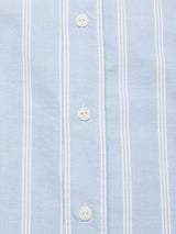 Close-up of the Sandro Caicos Shirt - Blue Stripe by Blue de Gênes, made in Portugal with Somelos fabric in light blue and white stripes. The 6oz fine stripe offers visible texture, complemented by white buttons and expertly stitched lines along the button area.