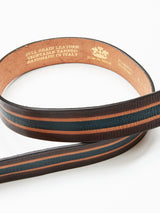 The Tino Belt - Brown Stripe by Blue de Gênes is handcrafted in Italy from full-grain leather, featuring brown and black stripes. It is vegetable tanned, showcasing quality craftsmanship.