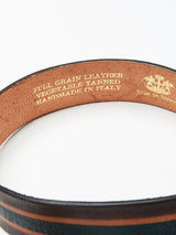 Close-up of Tino Belts interior from Blue de Gênes, highlighting FULL GRAIN LEATHER, VEGETABLE TANNED, HANDMADE IN ITALY. The belt showcases a brown stripe design with intricate stitching details.