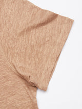 Close-up of a short-sleeved Totti T-Shirt - Taupe by Blue de Gênes, highlighting its natural texture fabric. Displayed on a white background, the focus is on the fabrics weave and the stitching around the sleeve and side seam.