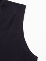 Close-up of a navy Zorba Knit Waistcoat by Blue de GĂȘnes on a white background, showcasing its textured fabric.