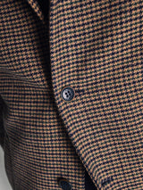 Close-up of the Blue de Gênes Massone Check Coat in a brown and black multi-check pattern, crafted from soft Melton wool with two buttons—showcasing its rich texture and stylish appeal for winter.