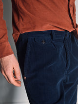 A person wears the Blue de Gênes Zamboni Velu Shirt in Henna, their left hand relaxed at their side. The photo highlights the shirt’s rich texture and color.