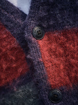 Close-up of the Blue de Gênes Block Knit Cardigan in a navy checkered pattern, featuring a soft chunky wool blend texture and two black buttons.