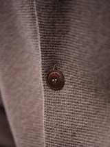Close-up of the Gifu Knit Cardigan - Chocolate by Blue de Gênes, highlighting a textured wool blend and a round brown button with four holes—a refined detail from this premium men’s knitwear.