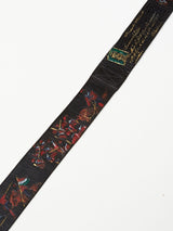 The Gari Belt - Black by Blue de Gênes showcases a martial arts design with vibrant embroidered samurai warriors and gold cursive text, featuring soldiers in red armor. This unique blend of intricate illustrations distinguishes it among premium leather accessories.