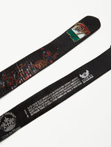 Close-up of two unique Gari Belt - Black crafted from premium leather with intricate designs; one features a colorful coat of arms, the other a detailed battle scene. Embossed text highlights the Blue de Gênes brand and shares its origins.